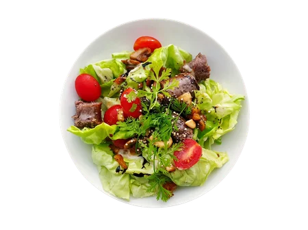 Bowl of fresh salad with tomatoes, lettuce and herbs